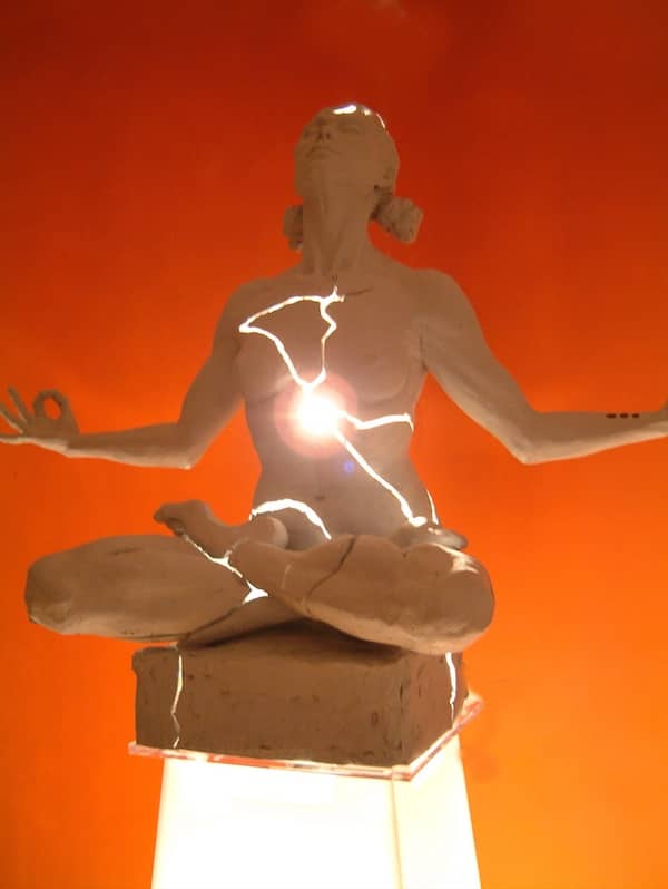 Cracked woman light sculpture orange background